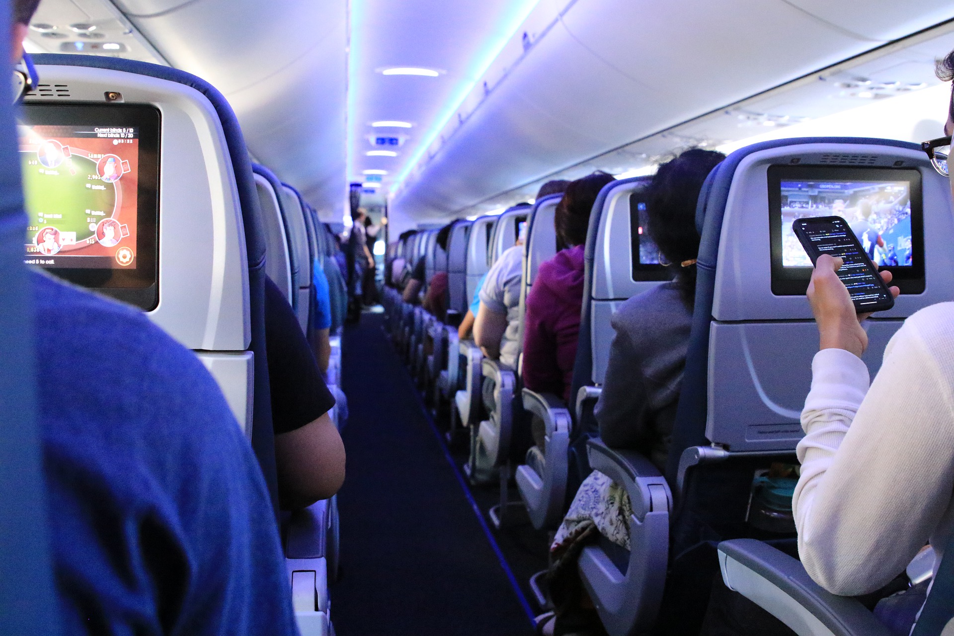 Inside an airplane full of people sitting in their seats